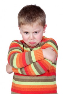 Angry child with crossed arm